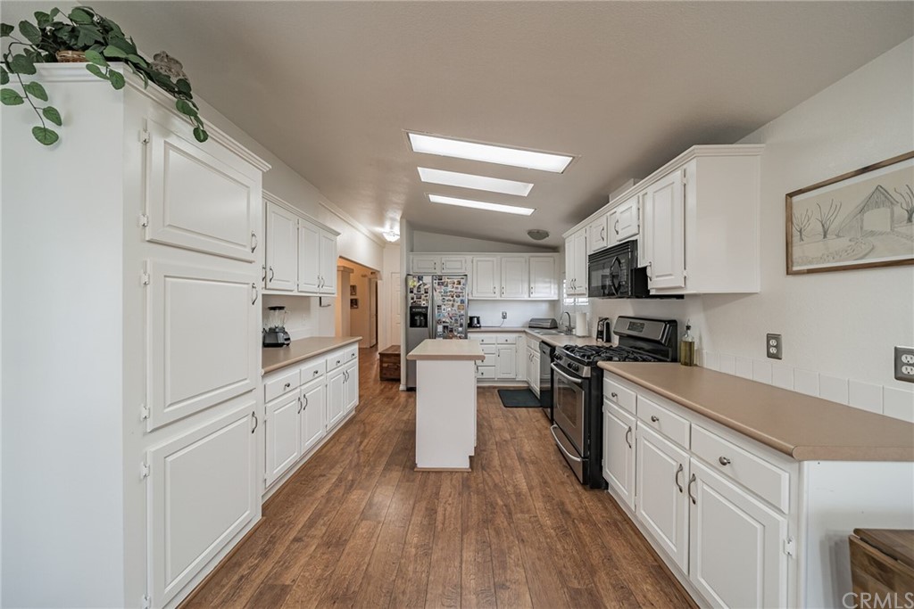 23301 Ridge Rte Drive, Unit 229 Laguna Hills, CA 92653 - Photo 6 of 26 a kitchen with white cabinets stainless steel appliances and sink