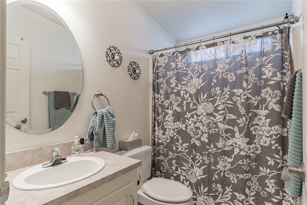 23301 Ridge Rte Drive, Unit 229 Laguna Hills, CA 92653 - Photo 10 of 26 a bathroom with a sink toilet and shower