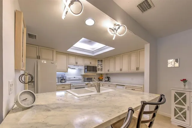 a kitchen with a sink cabinets and window