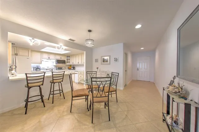 a kitchen with granite countertop a table and chairs in it