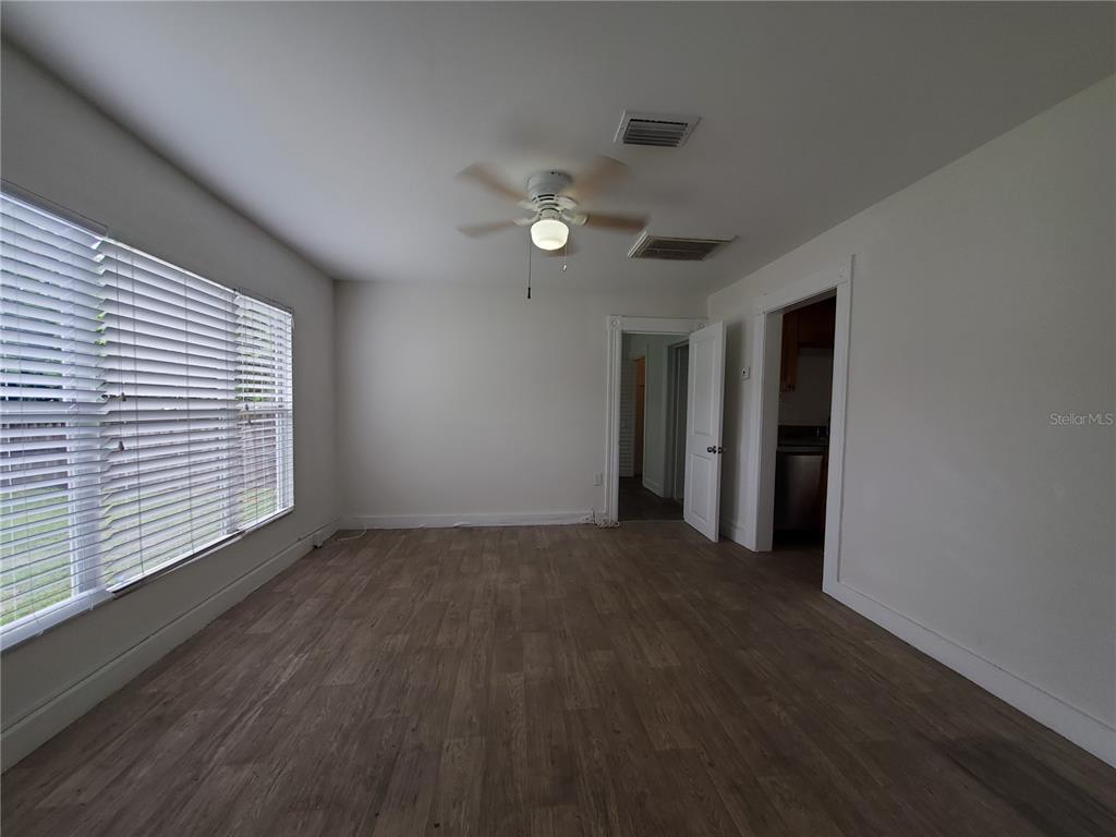 2703 West North A Street, Unit B Tampa, FL 33609 - Photo 3 of 10 a view of an empty room with wooden floor and a window