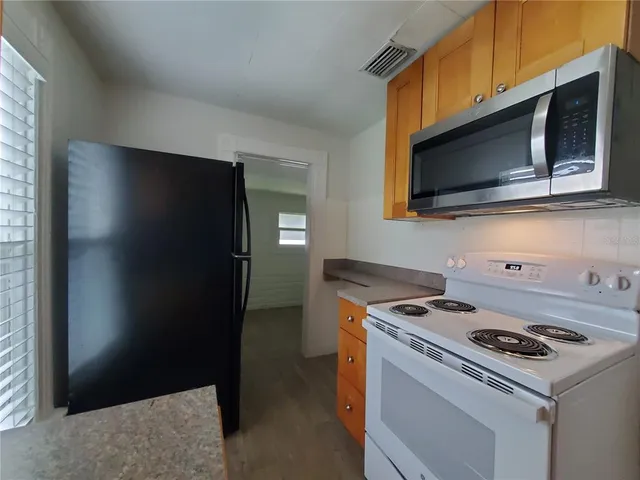 a kitchen with a stove microwave and refrigerator