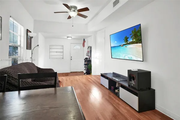 a living room with furniture and a flat screen tv