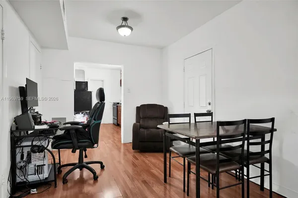a view of a workspace with furniture and wooden floor