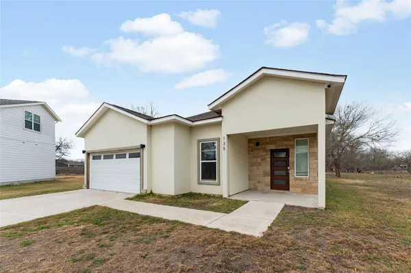 a view of a house with a yard and garage