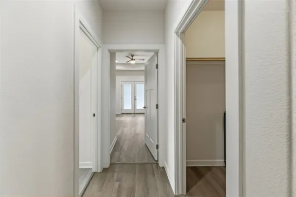 a kitchen with stainless steel appliances kitchen island granite countertop a stove a sink a refrigerator and a oven with wooden floor