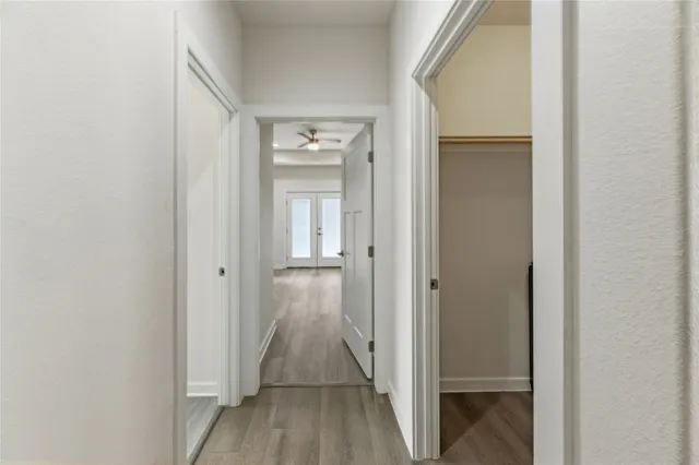 a kitchen with stainless steel appliances kitchen island granite countertop a stove a sink a refrigerator and a oven with wooden floor