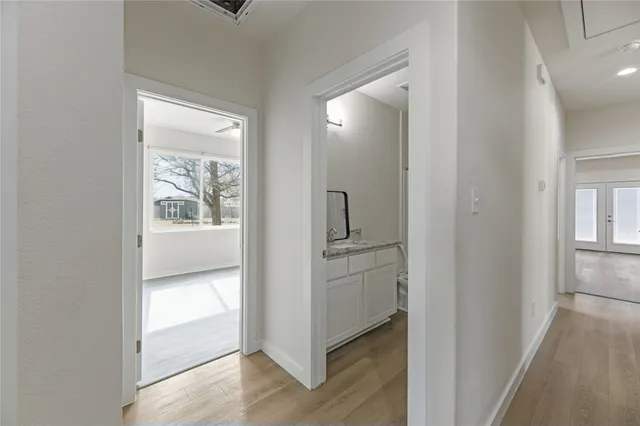 a view of a hallway with wooden floor