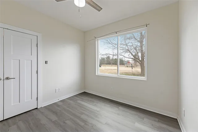 wooden floor in an empty room with a window