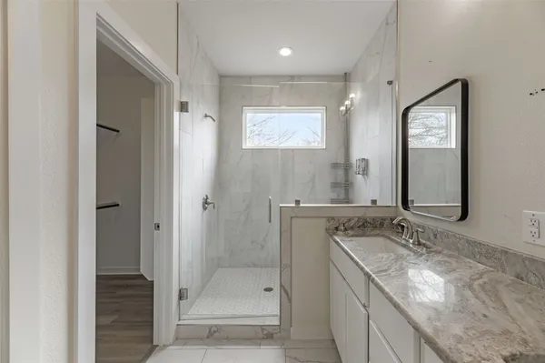 a bathroom with a granite countertop sink mirror and double
