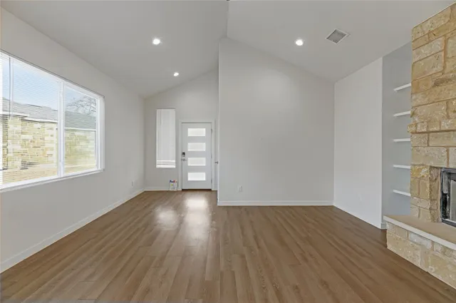 wooden floor in an empty room with a window