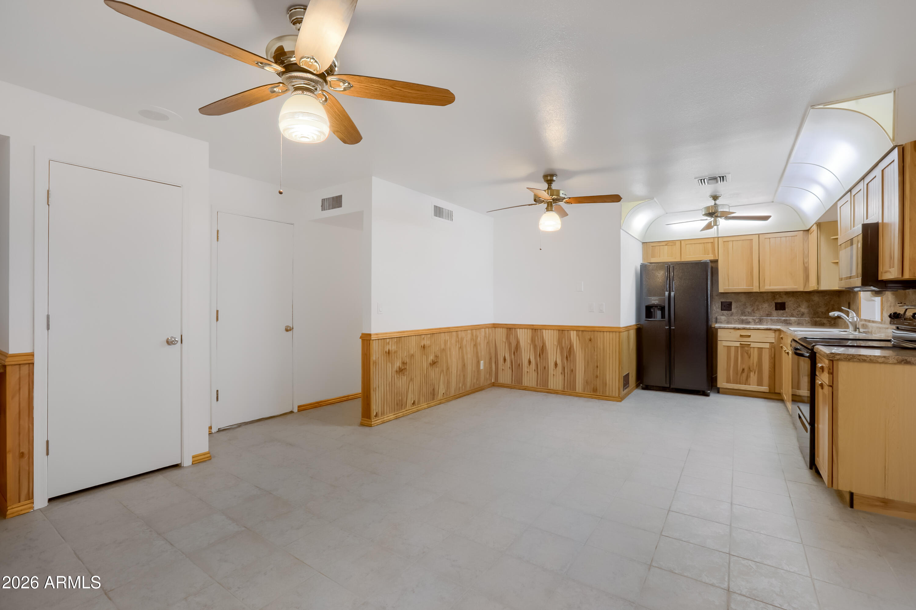 3823 West Greenway Road Phoenix, AZ 85053 - Photo 6 of 28 a view of a kitchen with a sink cabinets and a ceiling fan