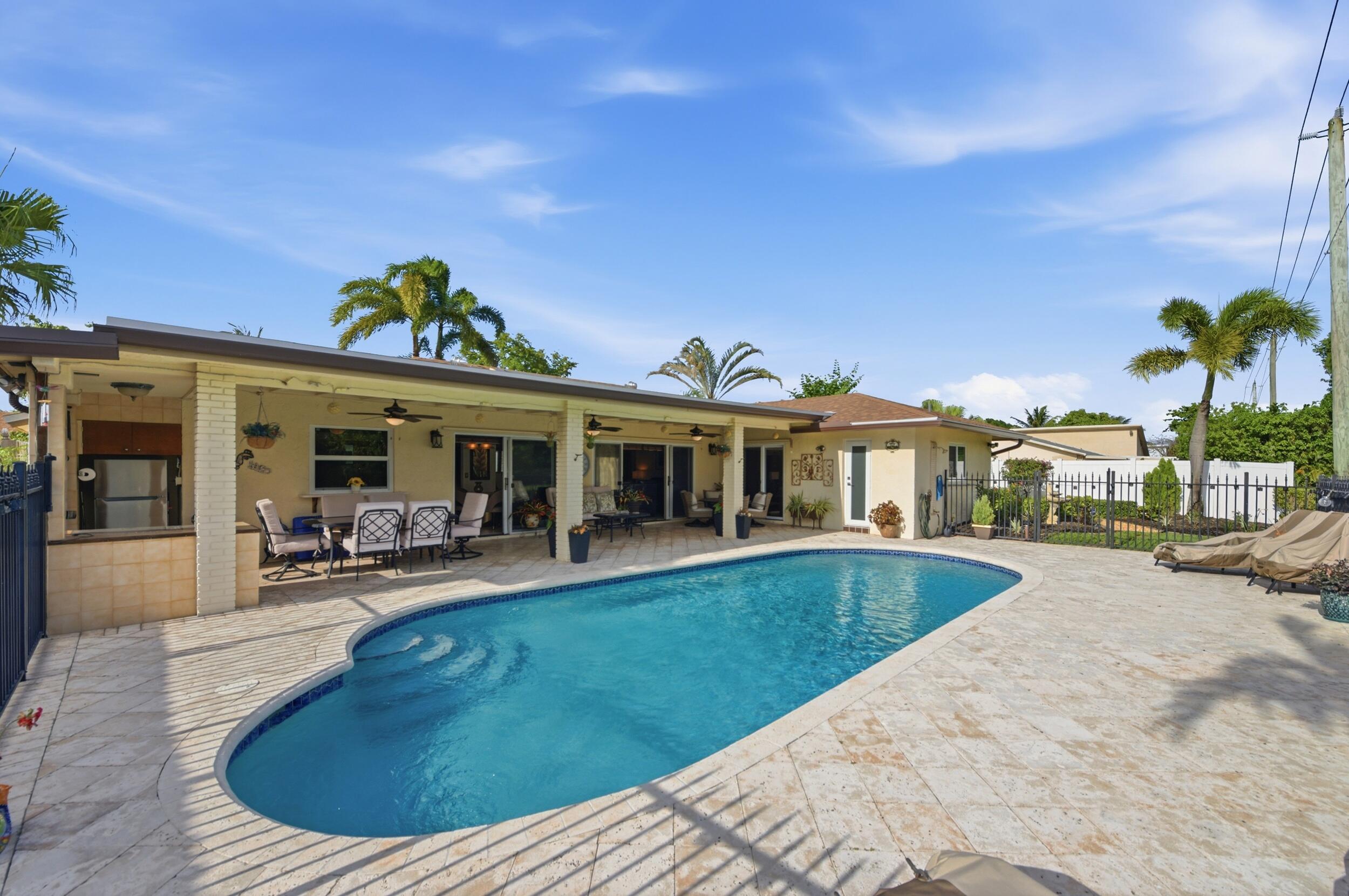 4780 Brandywine Drive Boca Raton, FL 33487 - Photo 32 of 43 a view of a house with swimming pool and sitting area