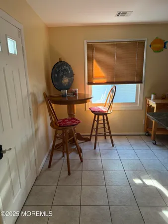 a view of a room with a table and a chair