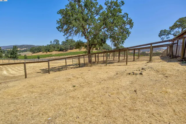 a view of a house with a yard and sitting area