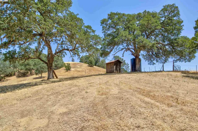 a view of a house with a tree in the background