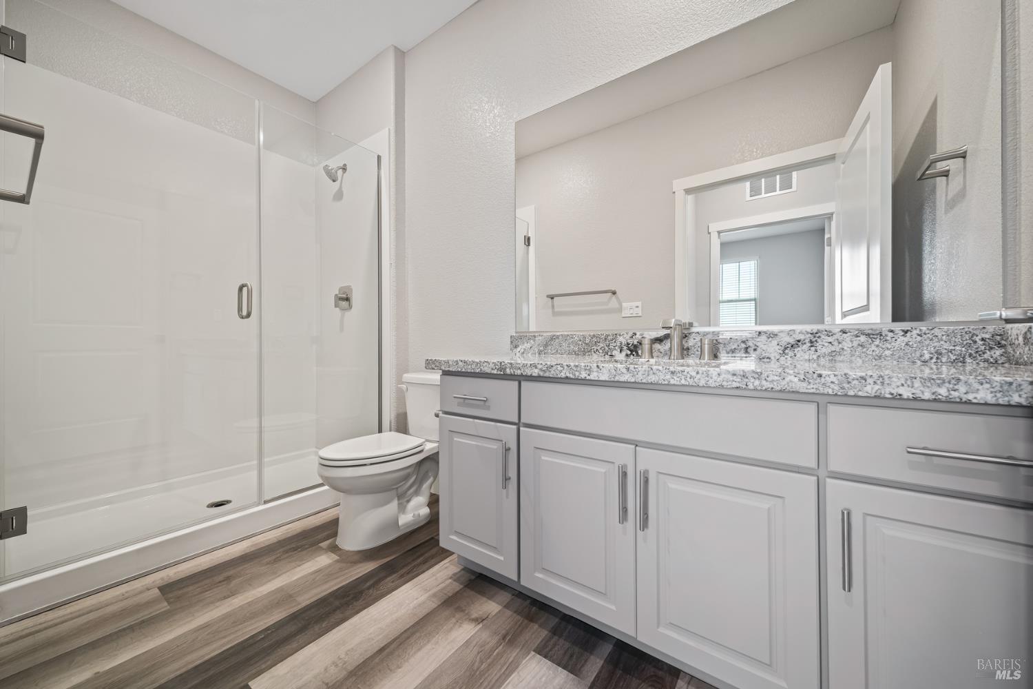 2194 Rustic Oak Lane Rio Vista, CA 94571 - Photo 10 of 20 a bathroom with a granite countertop toilet a sink and a mirror