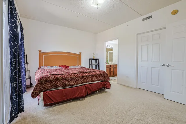 a bedroom with a bed and closet with window