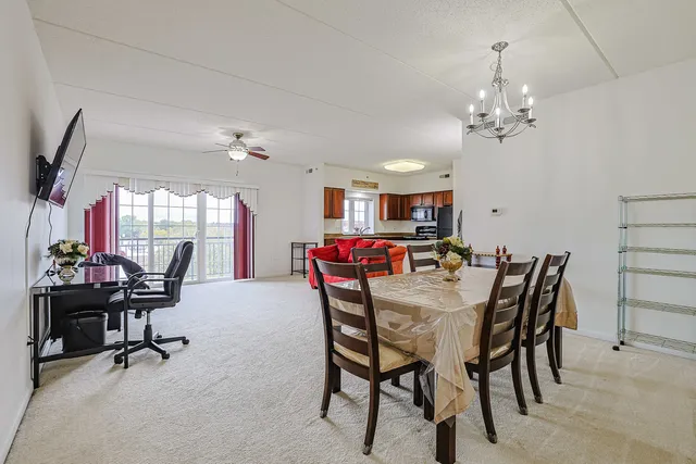 a view of a dining room with furniture and a chandelier