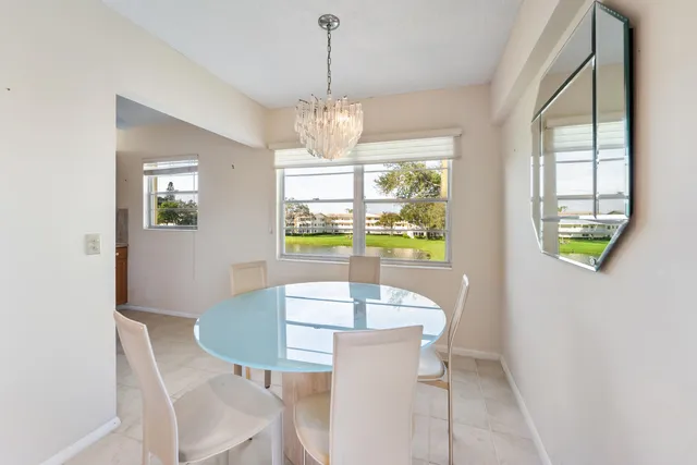 a view of a dining room with furniture a chandelier and wooden floor
