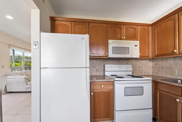 a white refrigerator freezer sitting in a kitchen