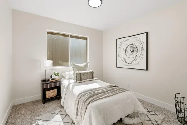 a bedroom with a bed and a lamp on table