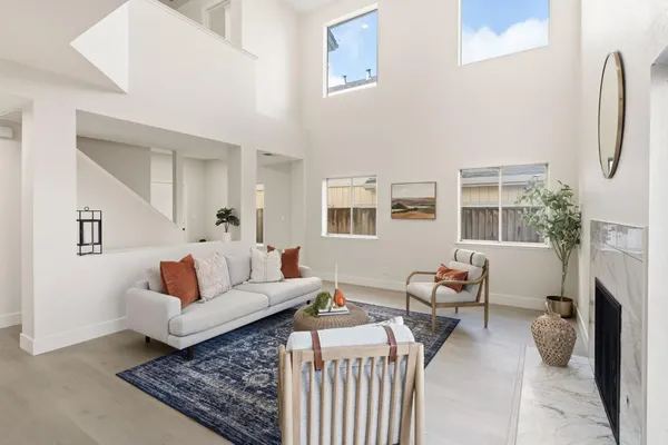 a living room with furniture fireplace and a window