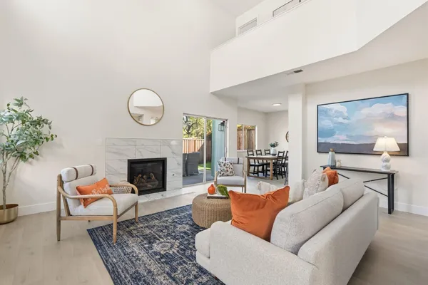 a living room with furniture a flat screen tv and a fireplace