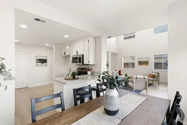 a living room with kitchen island furniture and a wooden floor