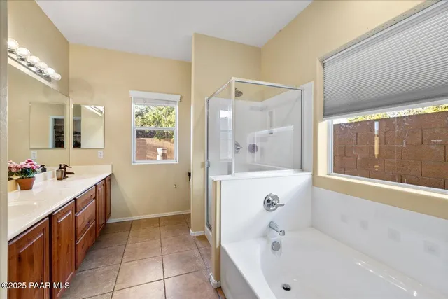 a bathroom with a tub a sink and mirror