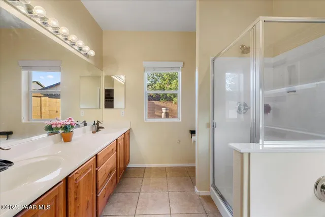 a bathroom with a sink mirror and a shower