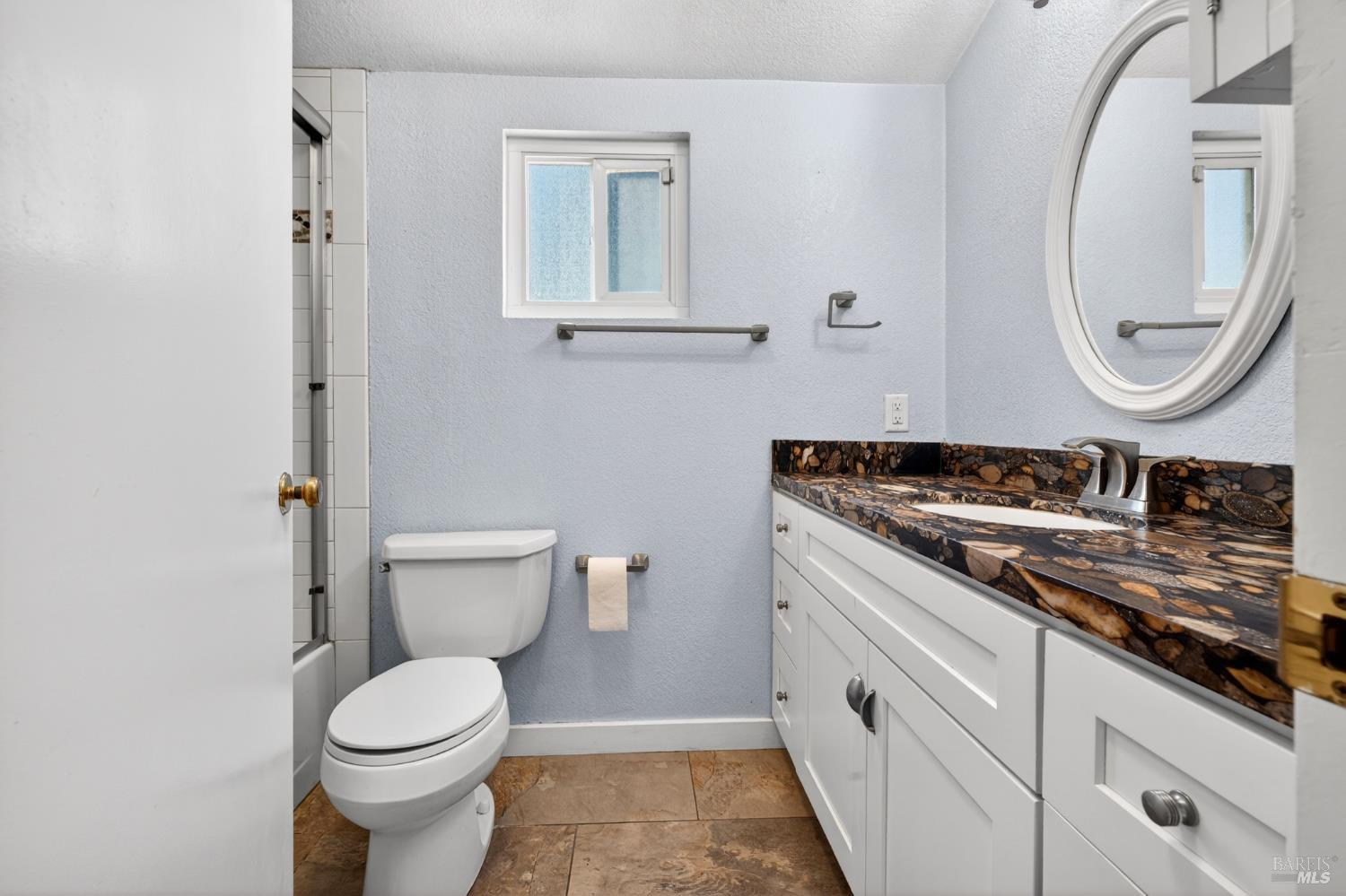 2757 Lakeview Drive Santa Rosa, CA 95405 - Photo 27 of 54 a bathroom with a granite countertop toilet sink and mirror