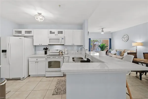a kitchen with stainless steel appliances a stove a sink cabinets and a refrigerator