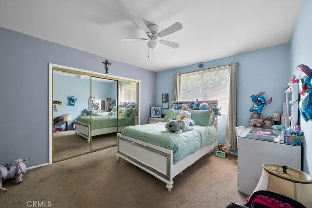 a bedroom with a bed and a couch