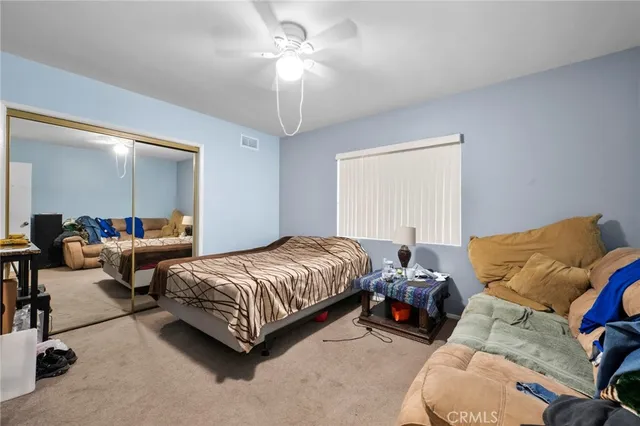 a bedroom with bed and a chandelier