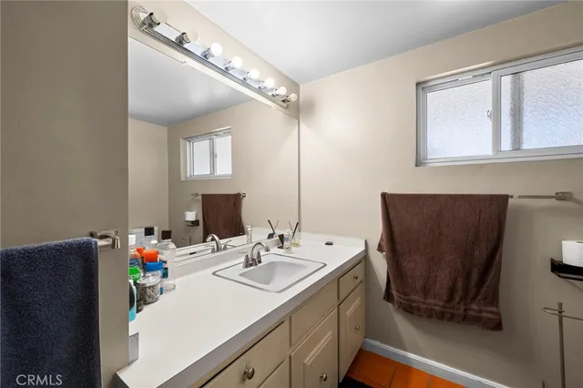 a bathroom with a sink vanity and a mirror