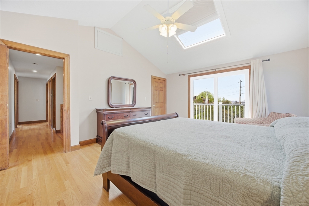 50 Harborview Road Hull, MA 02045 - Photo 19 of 41 a bedroom with a large bed and a chandelier