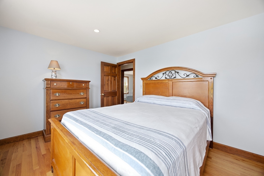 50 Harborview Road Hull, MA 02045 - Photo 22 of 41 a bedroom with a bed and wooden floor