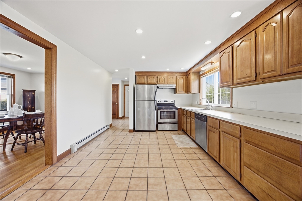50 Harborview Road Hull, MA 02045 - Photo 9 of 41 a kitchen with stainless steel appliances a refrigerator and a sink