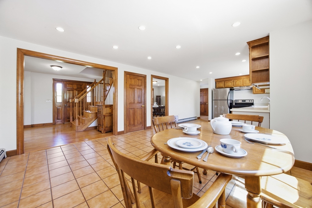 50 Harborview Road Hull, MA 02045 - Photo 10 of 41 a open dining room with stainless steel appliances kitchen island granite countertop a table and chairs in it