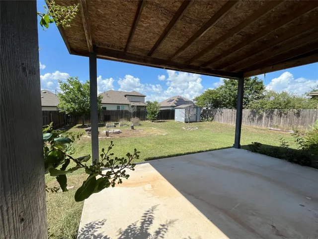 a view of a house with yard and sitting area