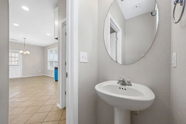 a bathroom with a sink a mirror and a shower