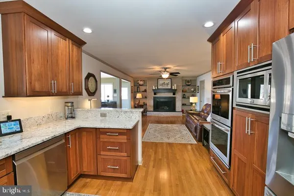 a bathroom with a granite countertop shower and a toilet