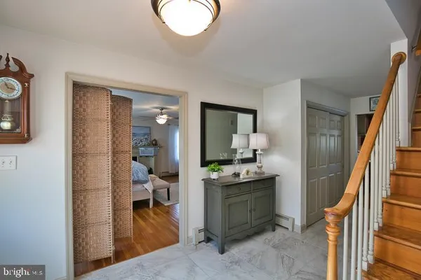 a bathroom with a granite countertop sink a toilet and a mirror