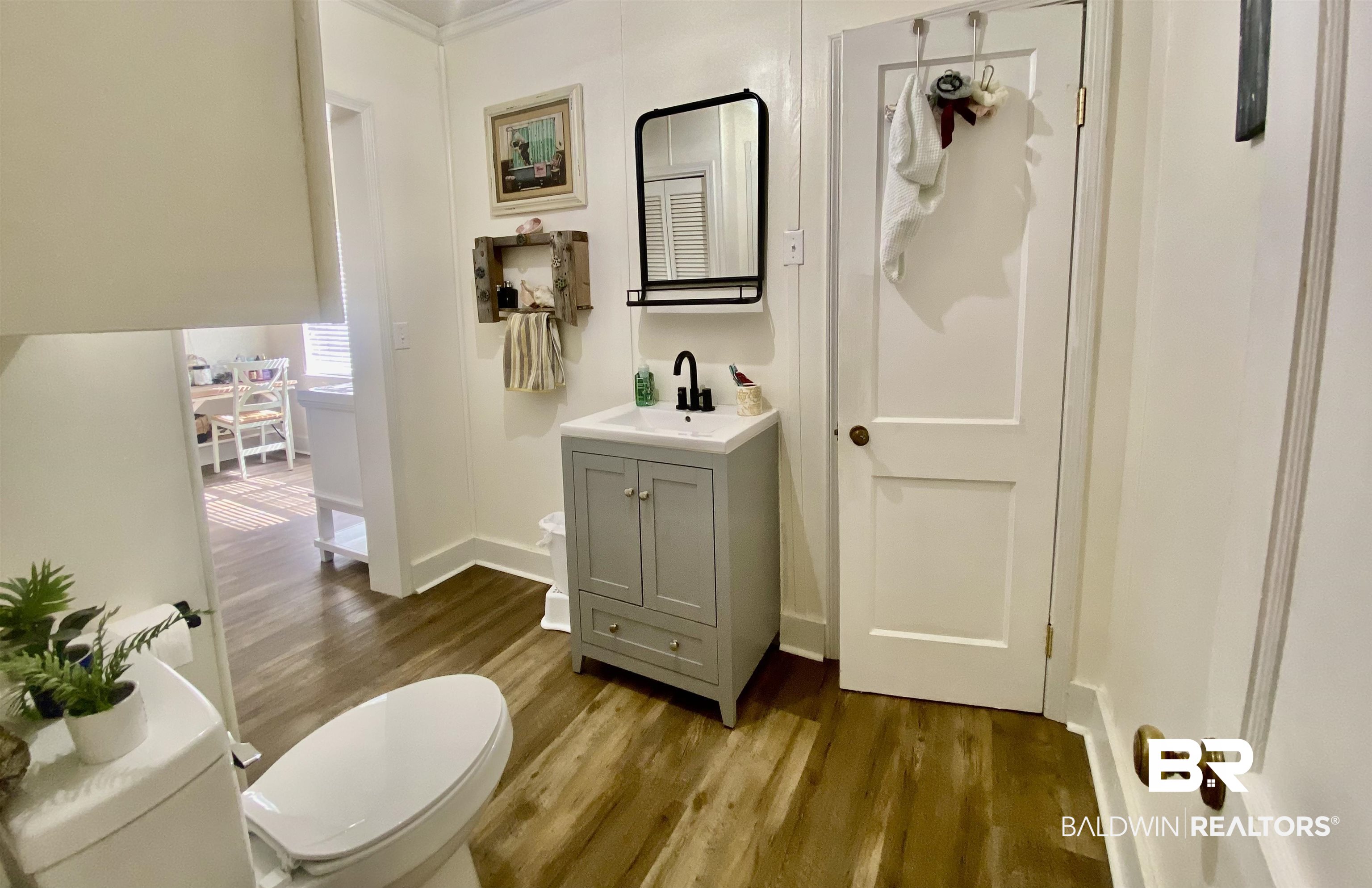 531 Highway 136 Monroeville, AL 36460 - Photo 27 of 48 Bathroom featuring ornamental molding, vanity, hardwood / wood-style flooring, and toilet