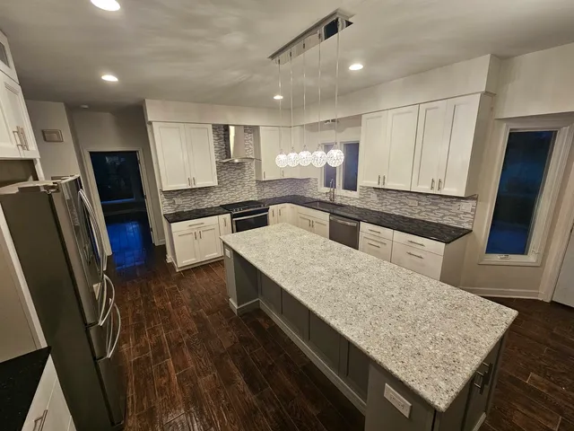a kitchen with a sink stainless steel appliances and cabinets