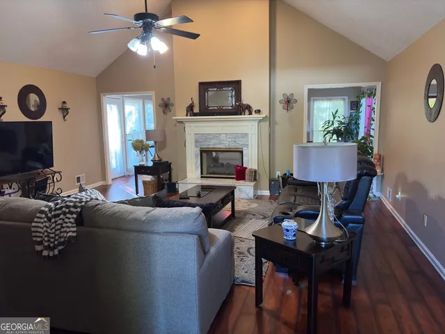 a living room with furniture a fireplace and a flat screen tv