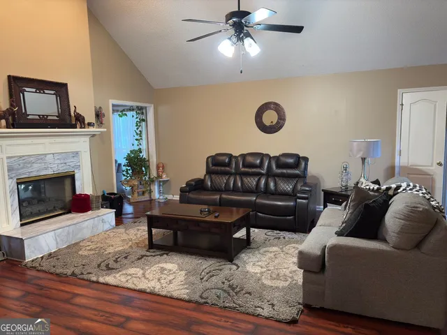a living room with furniture and a fireplace