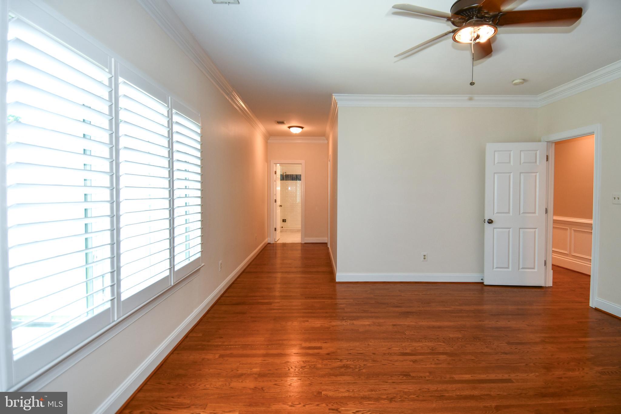 7808 Southdown Road Alexandria, VA 22308 - Photo 78 of 99 a view of empty room with wooden floor and fan