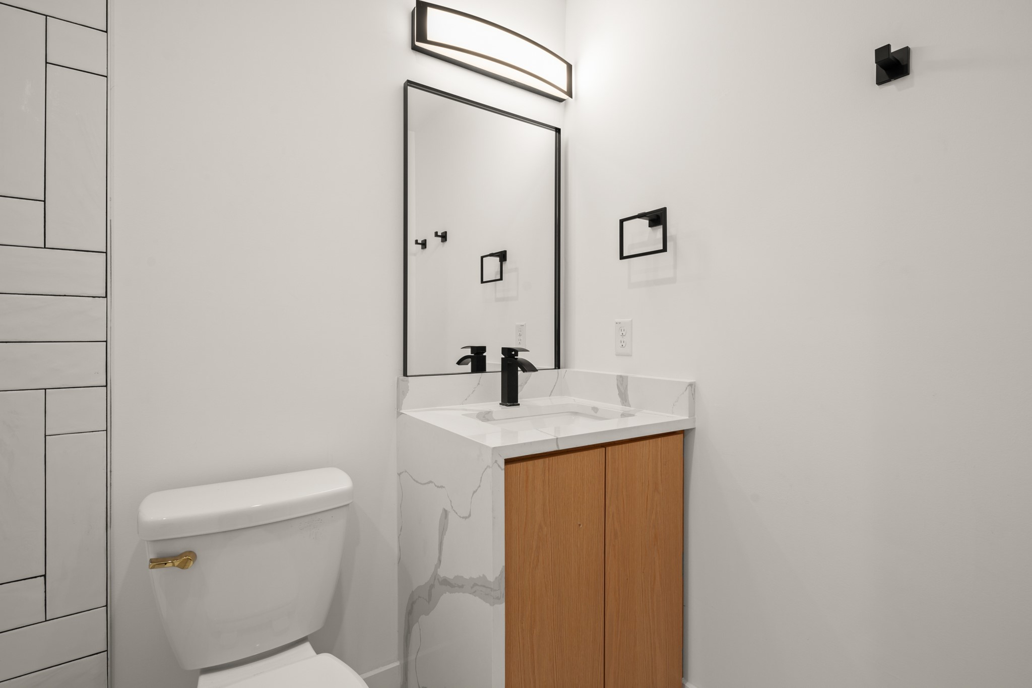 2416 East 10th Street Austin, TX 78702 - Photo 15 of 38 a bathroom with a granite countertop sink a toilet and mirror